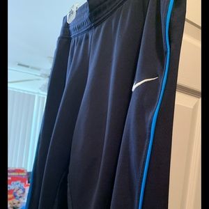 Nike dri-fit capris with royal blue striping on leg, two front pockets